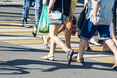 people walking across street summer weather