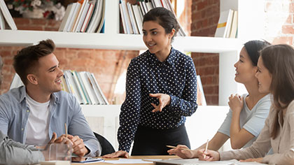 professional woman instructing team of interns