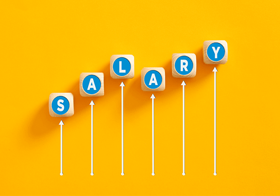 Salary raise or wage increase concept. The word salary on wooden cubes with an increasing graph.