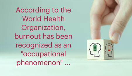 hand positioned on wooden cube showing 2 sides, showing human head with battery icons both empty and full and callout text: According to the World Health Organization (WHO), burnout has been recognized as an "occupational phenomenon