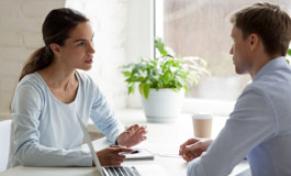 manager meeting with employee across desk