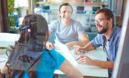 employees at conference table having discussion