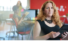 Professional Woman with documents looking at camera