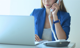 Woman at desk on phone