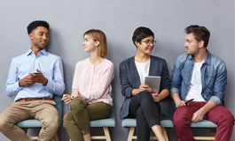 row of job candidates seated against wall